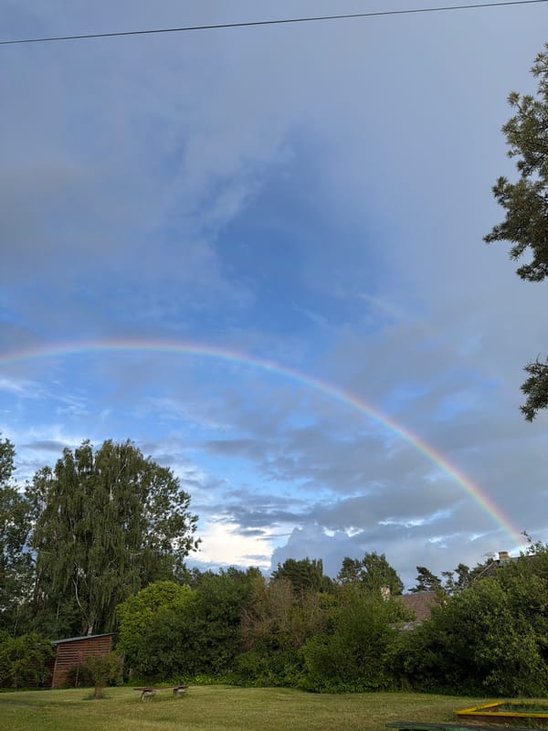 Rainbow over a quiet field in rural Latvia