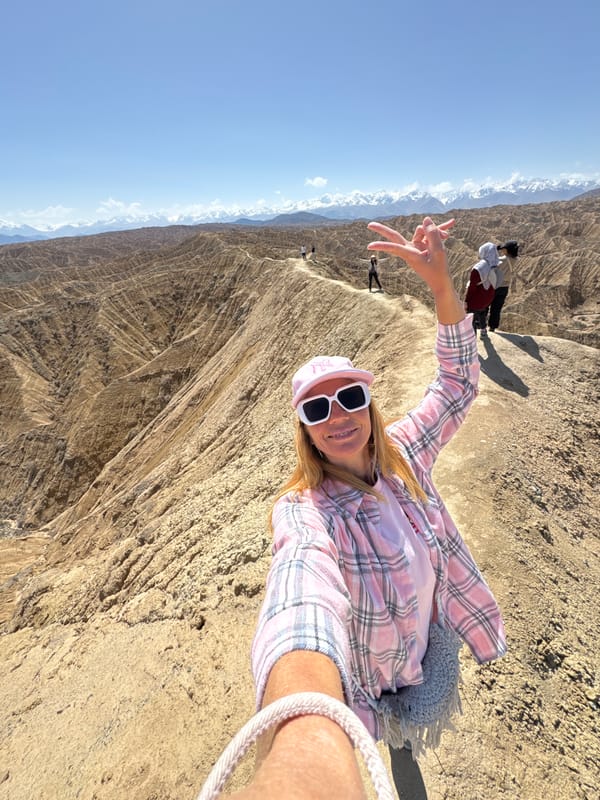 Woman poses for selfie on Kyrgyzstan ridge