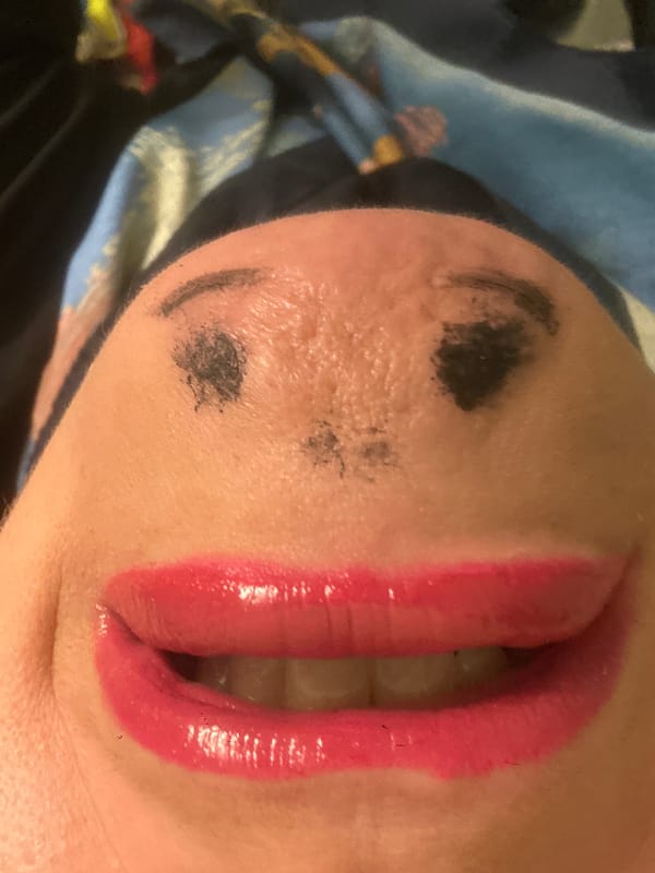 Person photographed with elaborate face makeup in Riga