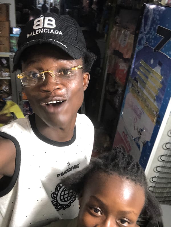 Hanging out in a packed neighborhood shop in Ado, Nigeria