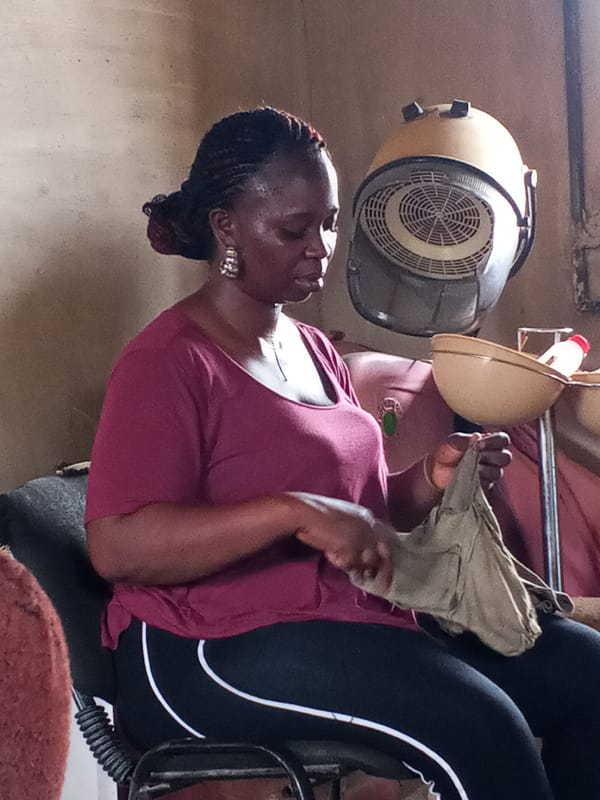 Woman sews garment in Nigerian beauty salon
