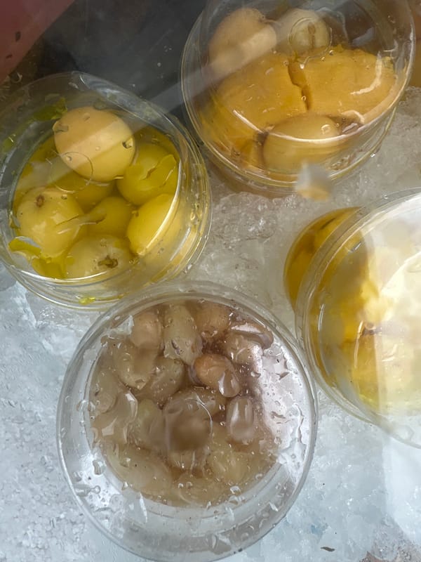 Fruit vendor serves preserved fruits from mobile stall in Koh Phangan