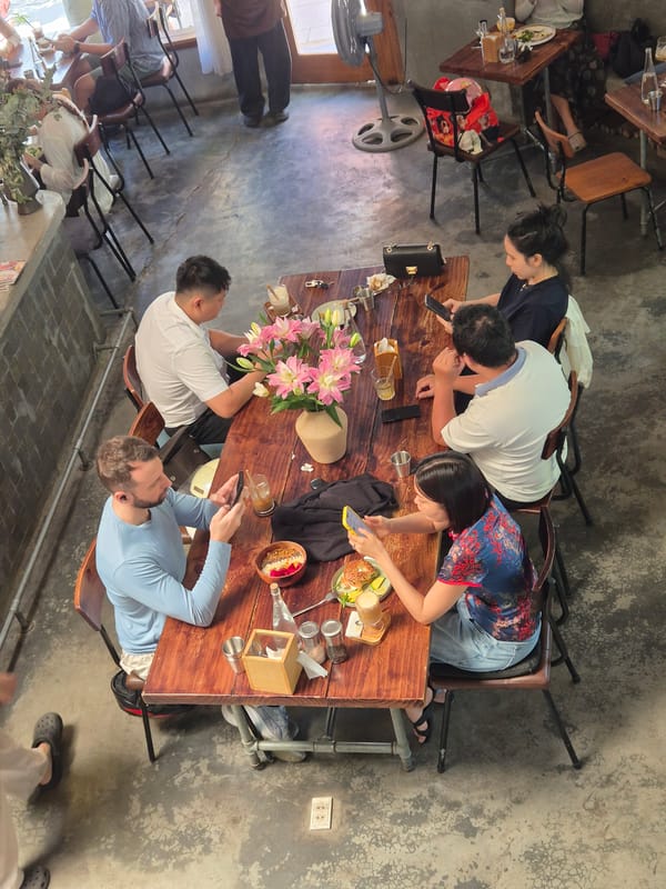 Cafe scene in Đà Nẵng with multiple patrons dining and working