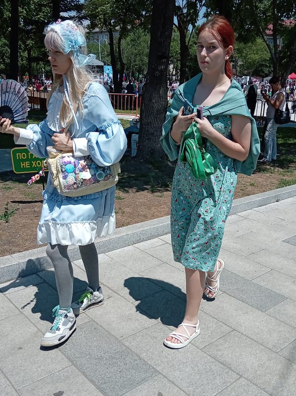 Cultural parade with traditional costumes and costumed horses in Artyom