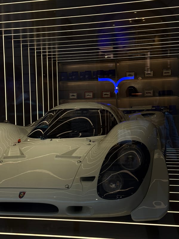 White sports car displayed in Milan showroom exhibit