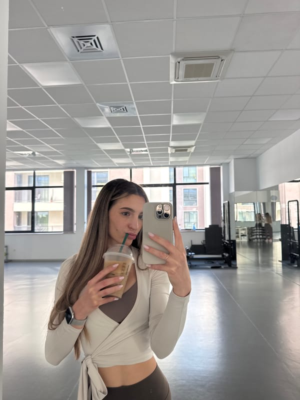 Woman Takes Coffee Break Selfies at Sofia Fitness Studio