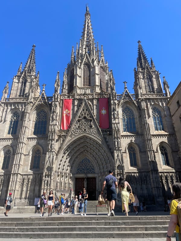 Tourists photograph Barcelona Cathedral and mosaic murals Friday afternoon