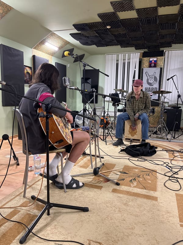 Musicians prepare for recording session in soundproofed studio