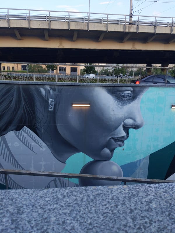 Kyiv underpass murals mix portraits, geometry, and street color