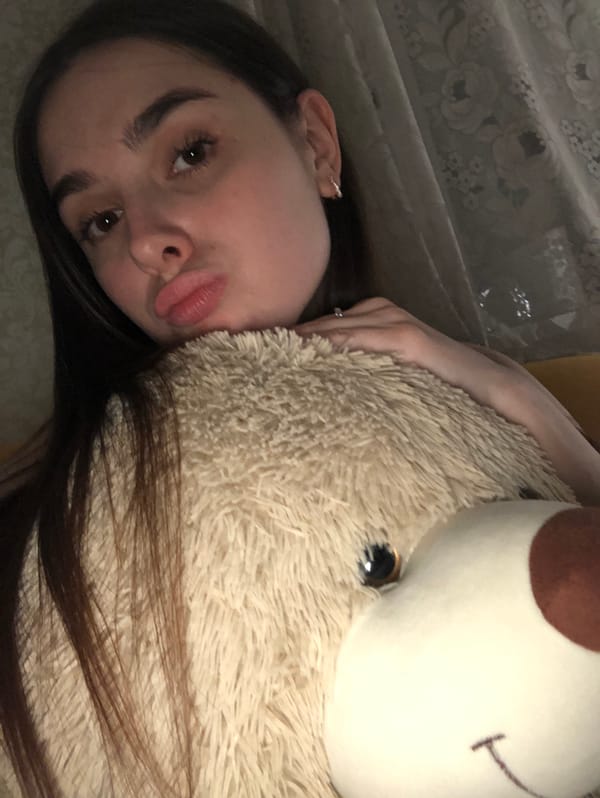 Woman takes bathroom selfies while cat poses nearby