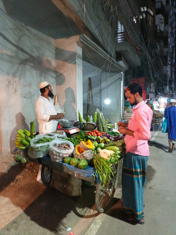 Evening street vendors operate across Dhaka amid stray dogs