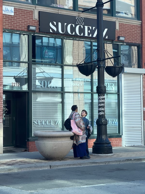 Chicago building with 'SUCCEZZ' signage documented in evening street scene