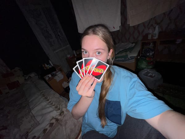 Friends gaming together with video games and UNO cards
