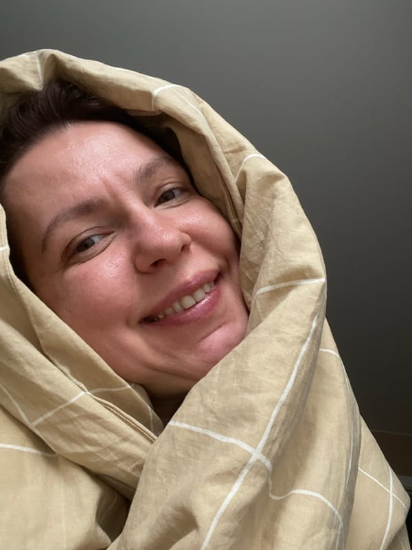 Woman photographed smiling under blanket in Chaikovsky, Russia