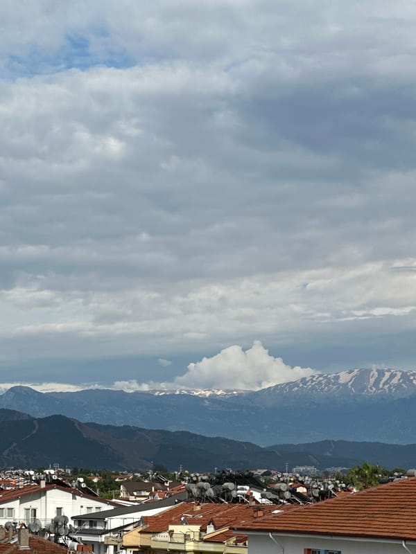 Elevated view captures Fethiye cityscape under cloudy Turkish skies