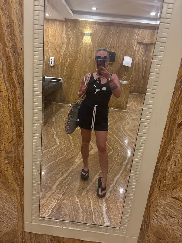 Person in black tank top seen in bathroom mirror, Egypt