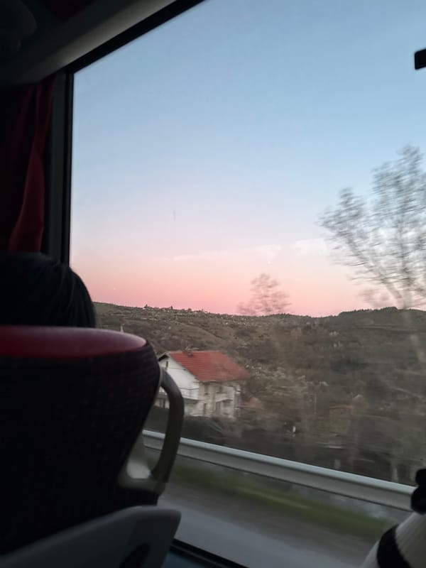 Traveler documents Bulgarian hillside landscape from moving vehicle