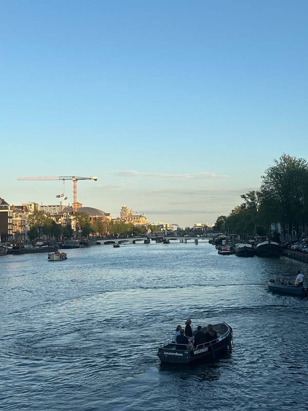 Golden hour on Amsterdam's canals, police activity nearby