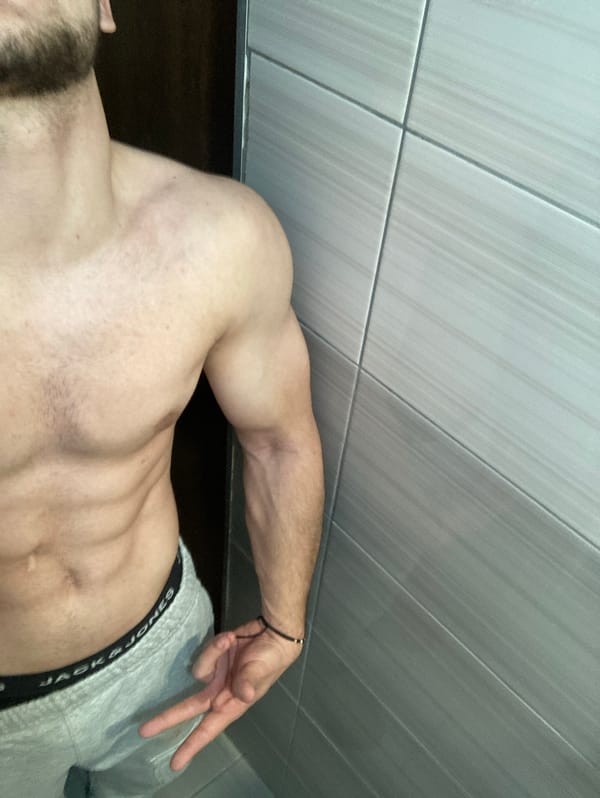 Man takes shirtless selfies and poses indoors in Bulgaria