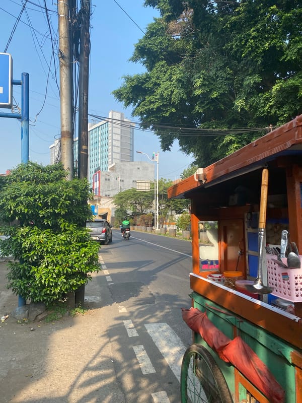 Sunny midday street life near Atika Hotel, East Jakarta