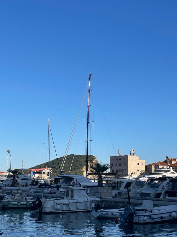 Tourist moments captured around Budva Marina on sunny afternoon