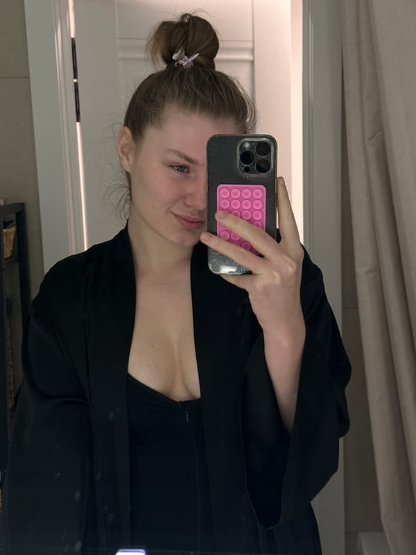 Person cleans mirror, takes bathroom selfie in Kazan