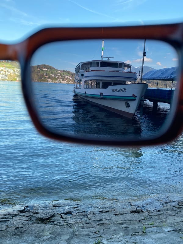 Boat 'Winkelried' docked at Lucerne pier viewed through sunglasses