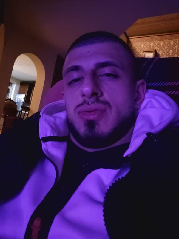 Man takes indoor selfie under purple lighting in Bankya