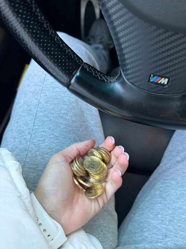 Driver holds Euro coins in BMW in Gabrovo