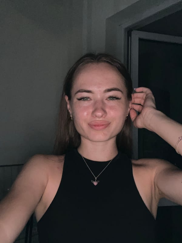 Indoor selfie session, black top and pink heart necklace