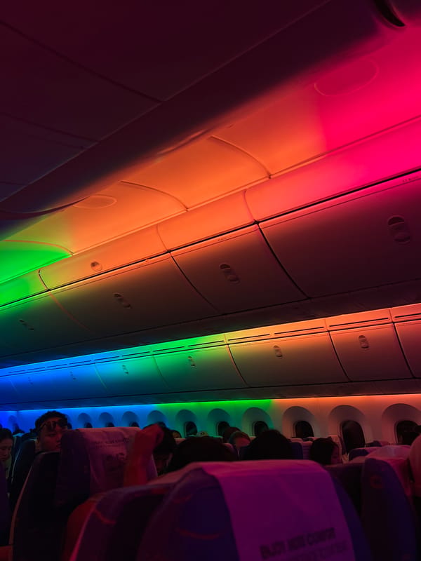 Rainbow LED lighting fills an airplane cabin at night