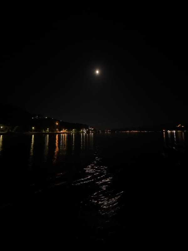 Ferry crossing captured under moonlight between Montenegro coastal towns