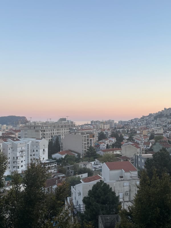 Woman holds strawberry, yawns and smiles in Budva
