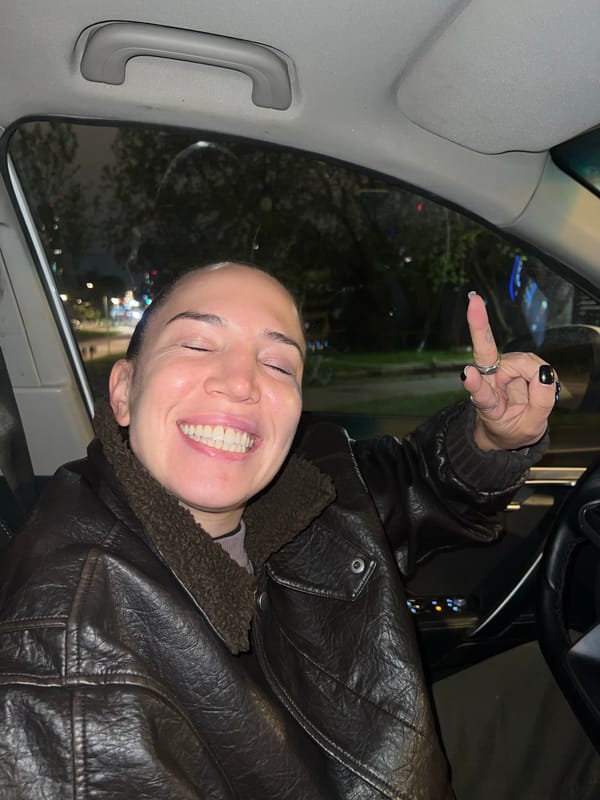 Person in leather jacket gestures from car in Moscow