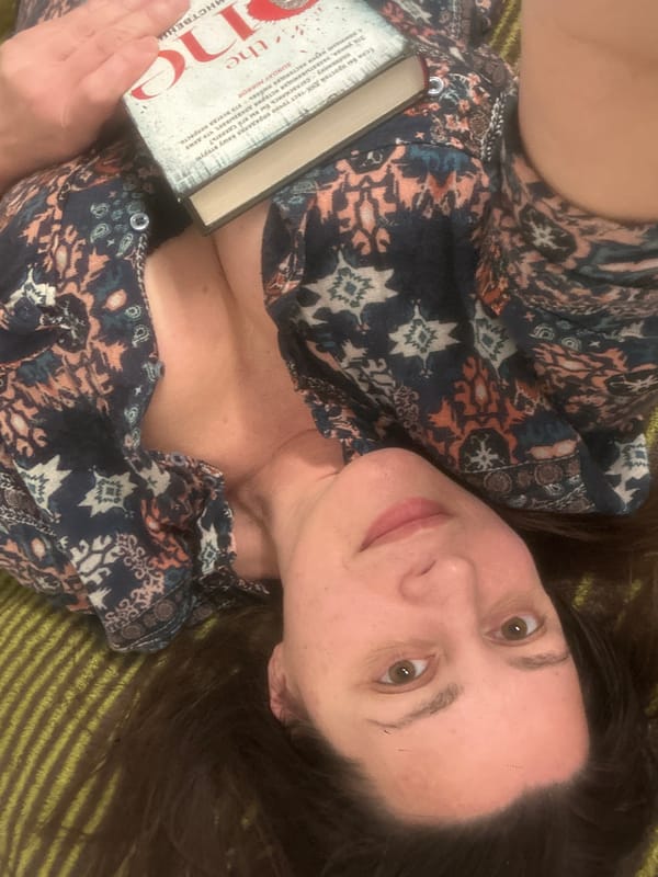 Reader examines seashells while enjoying book in Riga