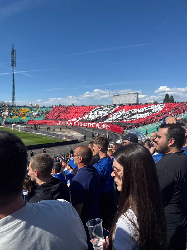 Soccer fans in blue and yellow gather at stadium
