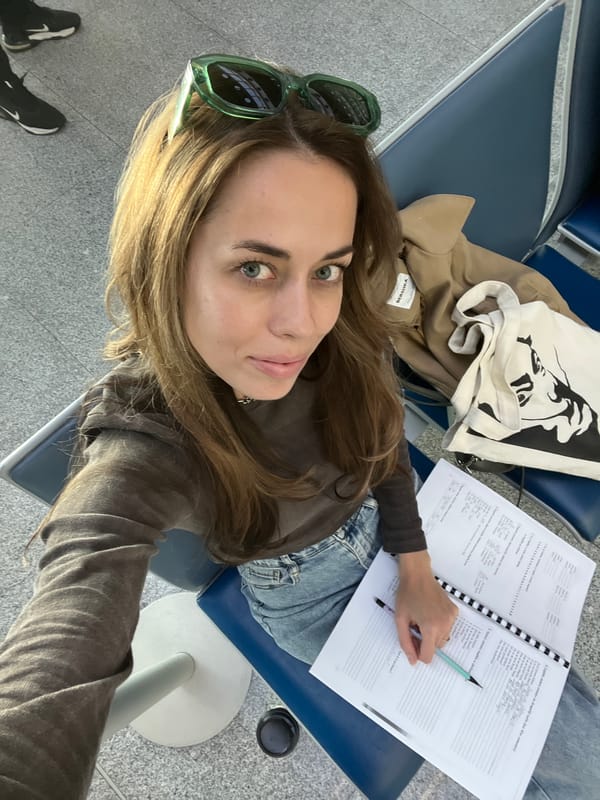 Woman studies Serbian at Montenegro airport awaiting mother reunion