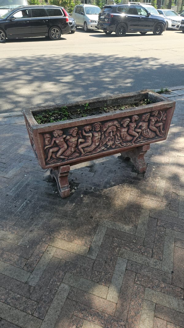 Ornate carved planter photographed on Chișinău street