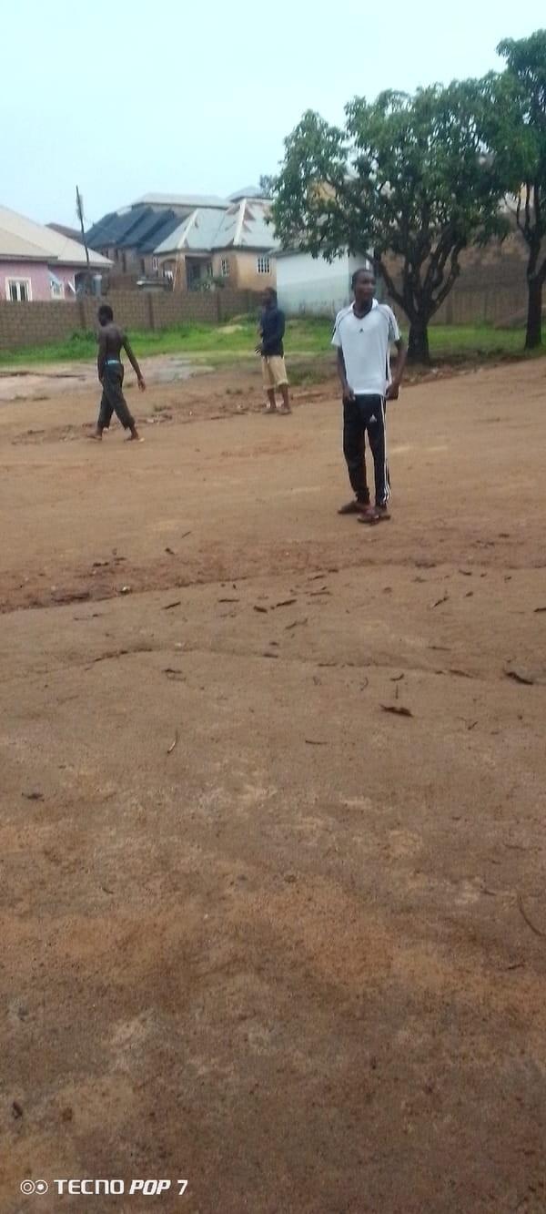 Soccer game on dirt field in residential area