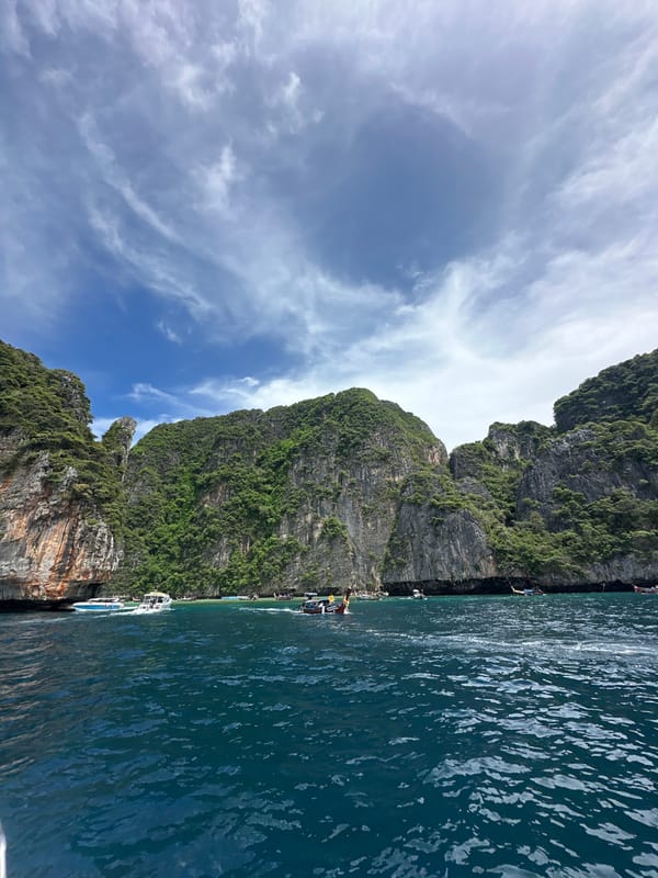 Boats and karst cliffs at Haad Yao, southern Thailand