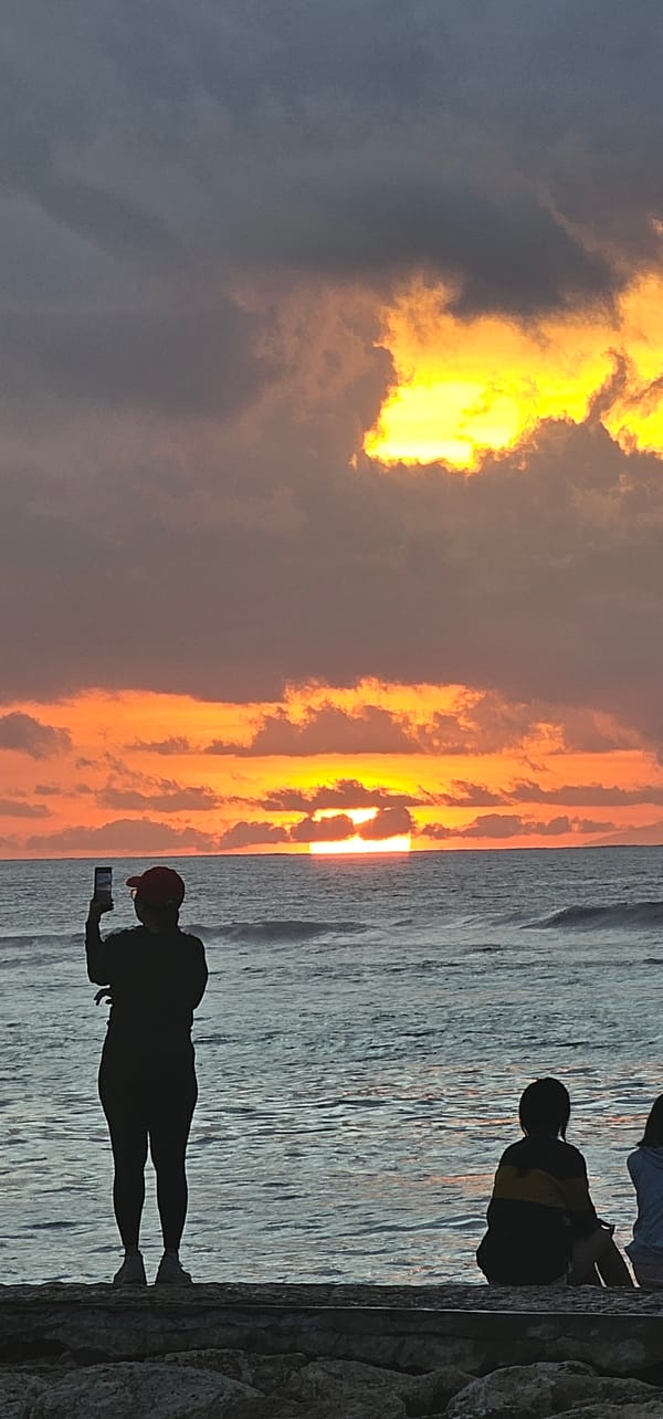 Sunset watchers gather along Denpasar beaches during golden hour