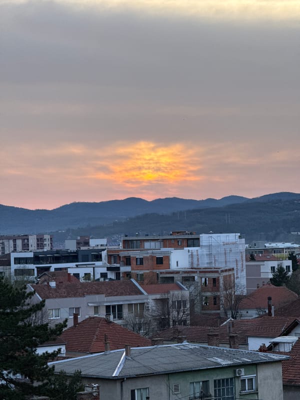 Sunset observed over Kragujevac cityscape with mountain backdrop