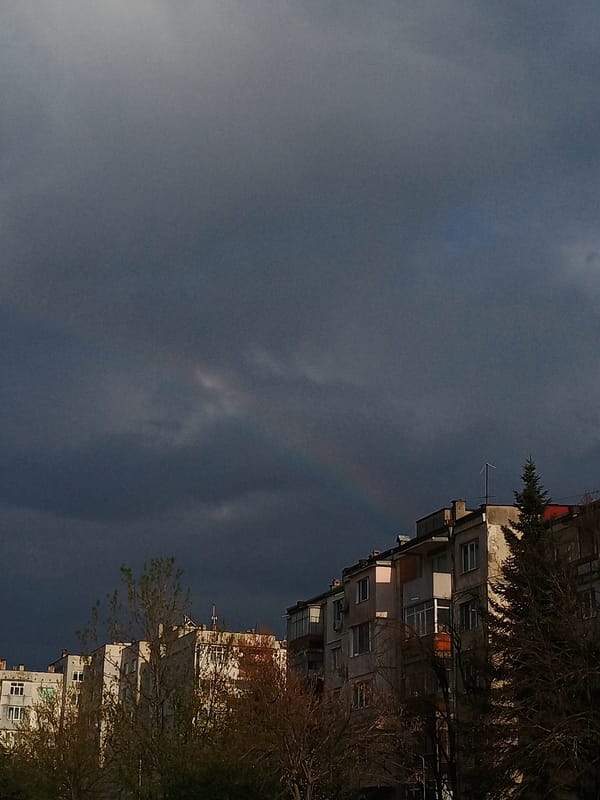 Faint rainbow appears over Veliko Tarnovo apartment buildings