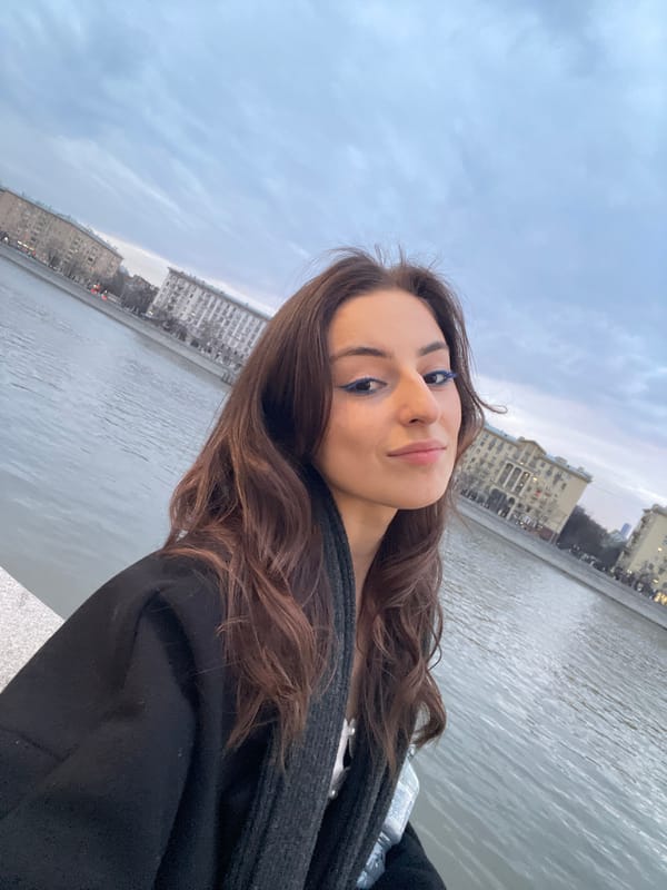 Woman takes selfies by Moscow river with blue makeup