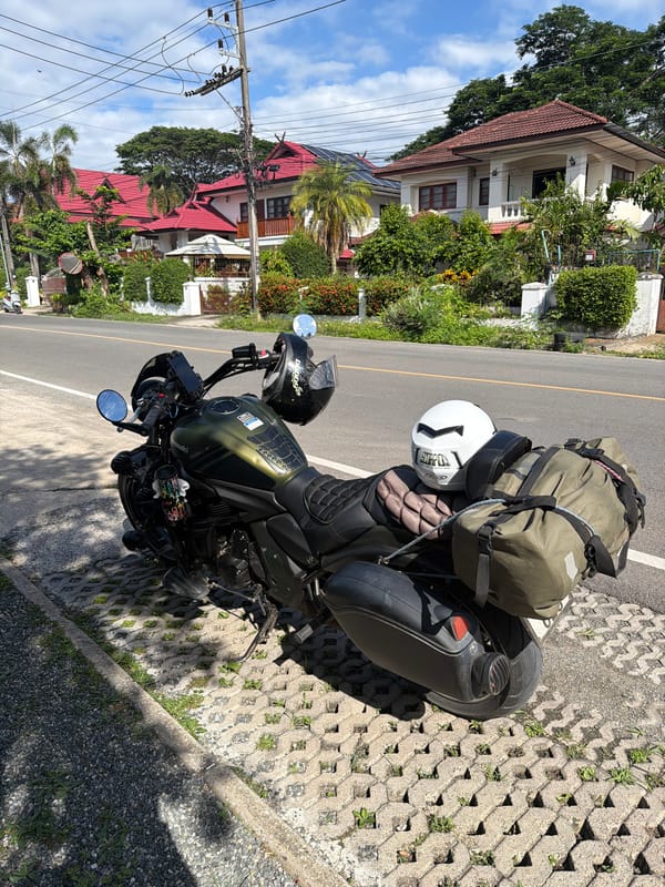Morning cafe stop in Chang Phueak with a loaded touring motorcycle outside