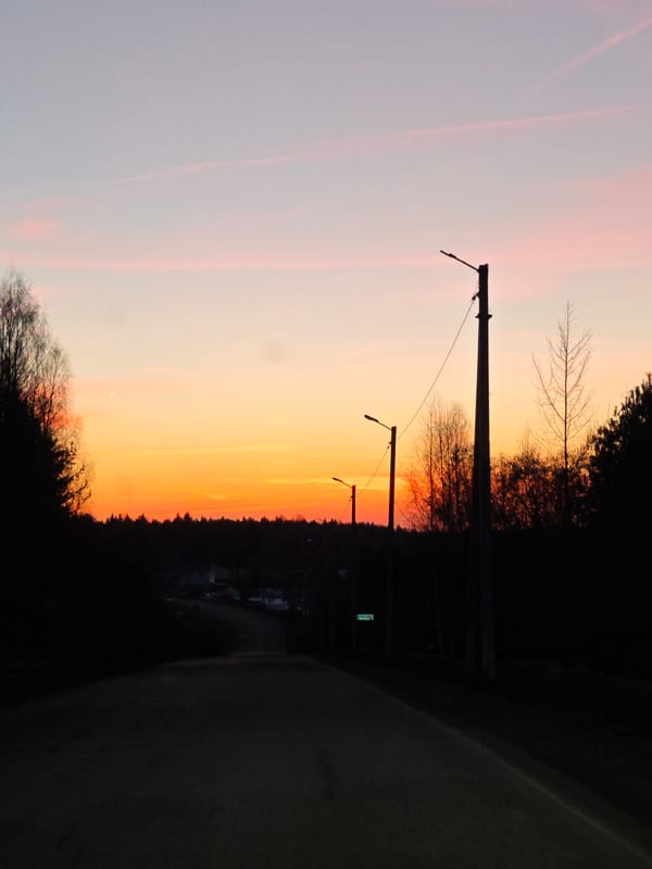 Colorful dusk sky captured over street in Markovo, Russia