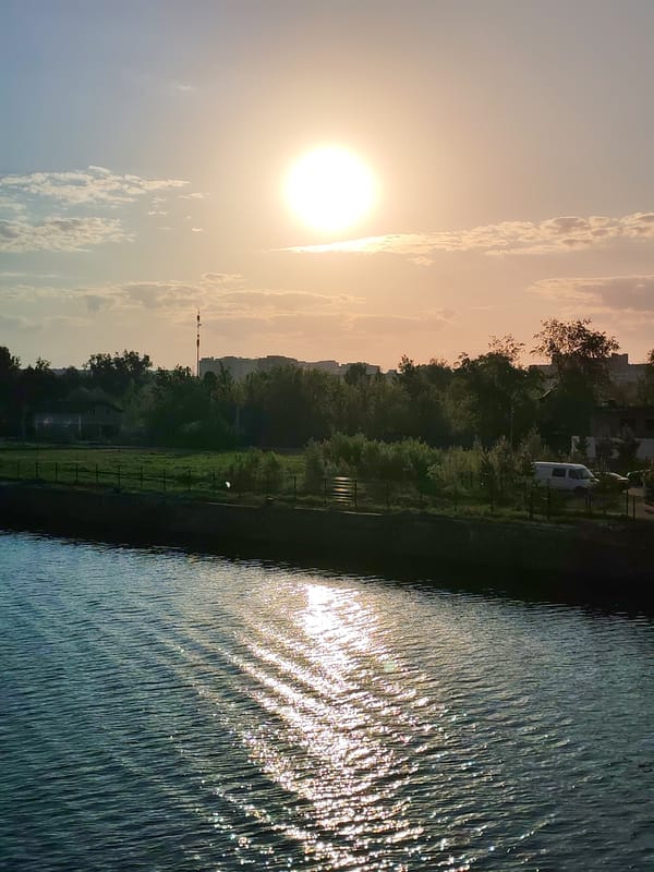 Sunset observed over Dmitrov waterfront with residential buildings