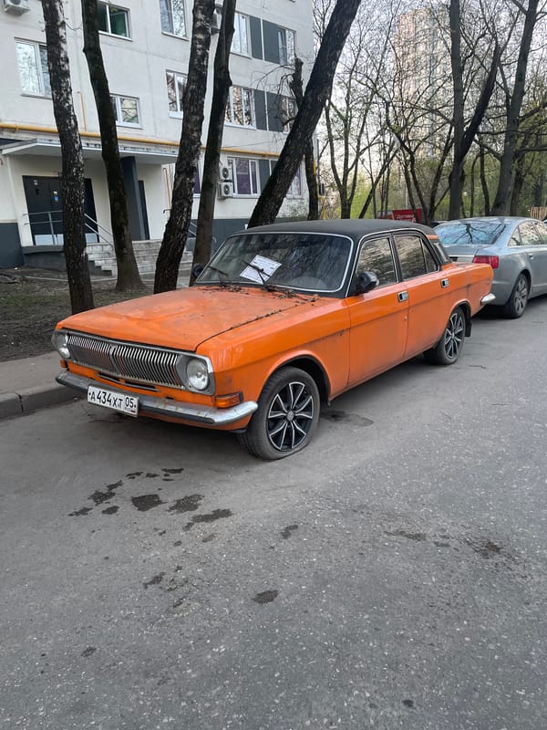 Vintage orange Volga with flat tire spotted in Moscow