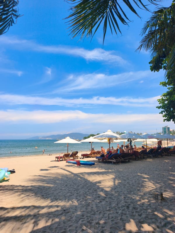 Sun-soaked beach morning at Nha Trang, lounge chairs ready