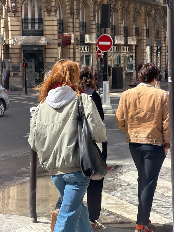 Ordinary street life observed in sunny Paris neighborhood
